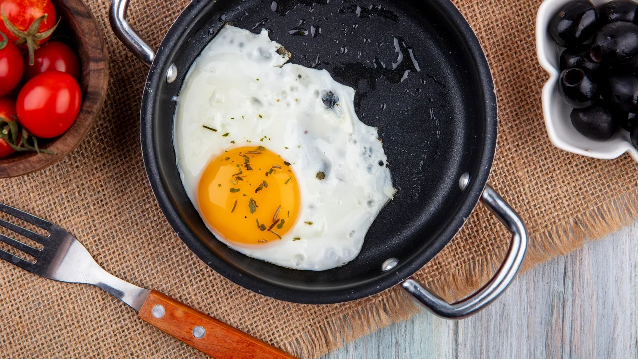 Dlaczego zaleca się dodawanie octu do patelni podczas smażenia jajek?